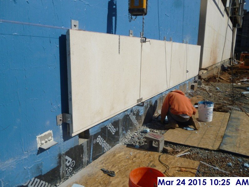 Installing the hand set stone panels at the shear walls (South Elevation)